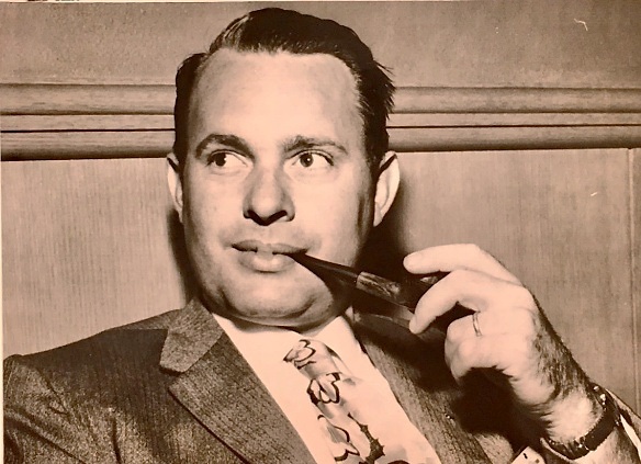 Henry Richter in 1959, in a tweed jacket and patterned tie, holding a pipe