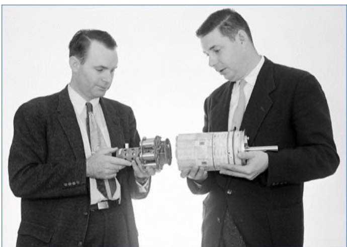Henry Richter holding the Microlock transmitter beside George Ludwig holding the cosmic ray package